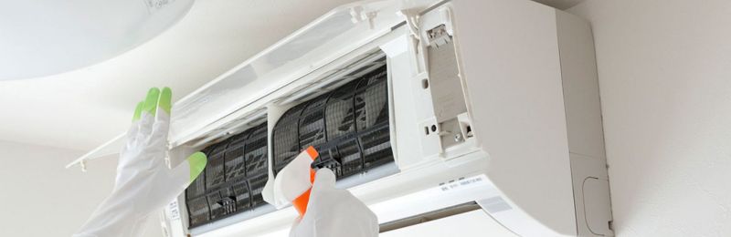 HVAC technician repairing an air conditioner unit in Encinitas CA